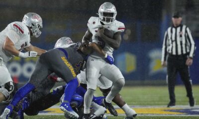 Unlv Rebels Football Team Celebrating Win In The Rain