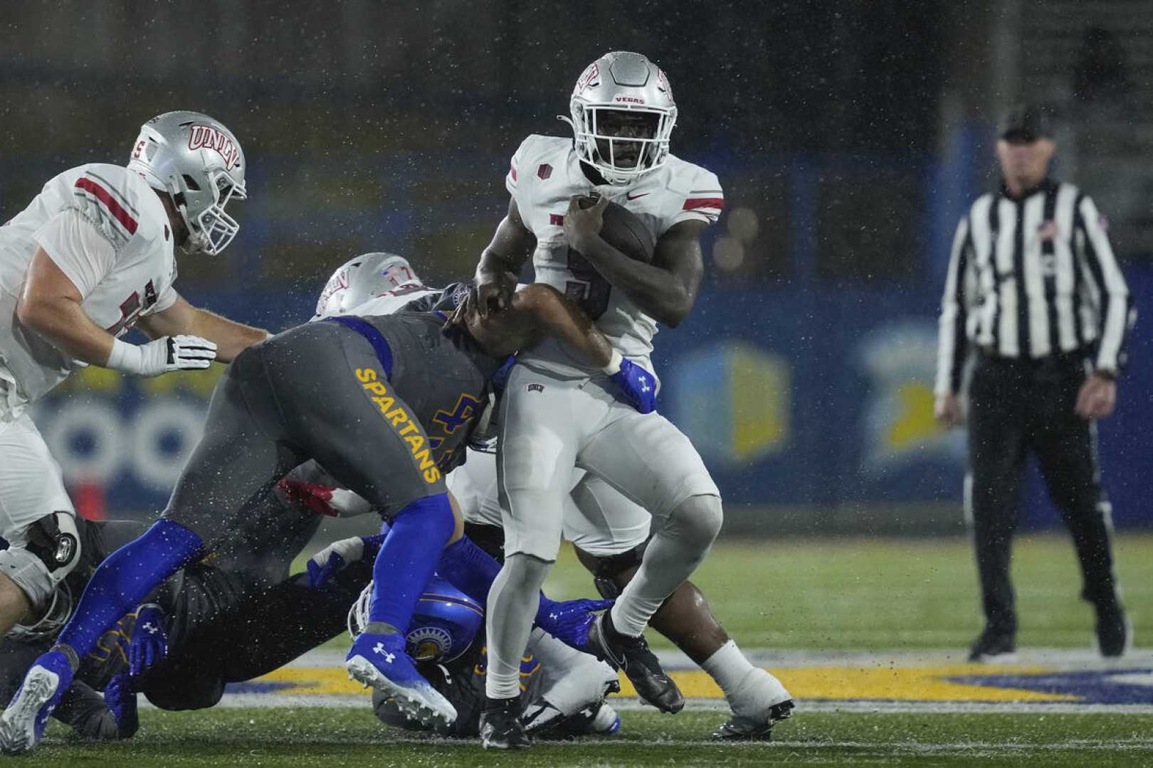 Unlv Rebels Football Team Celebrating Win In The Rain