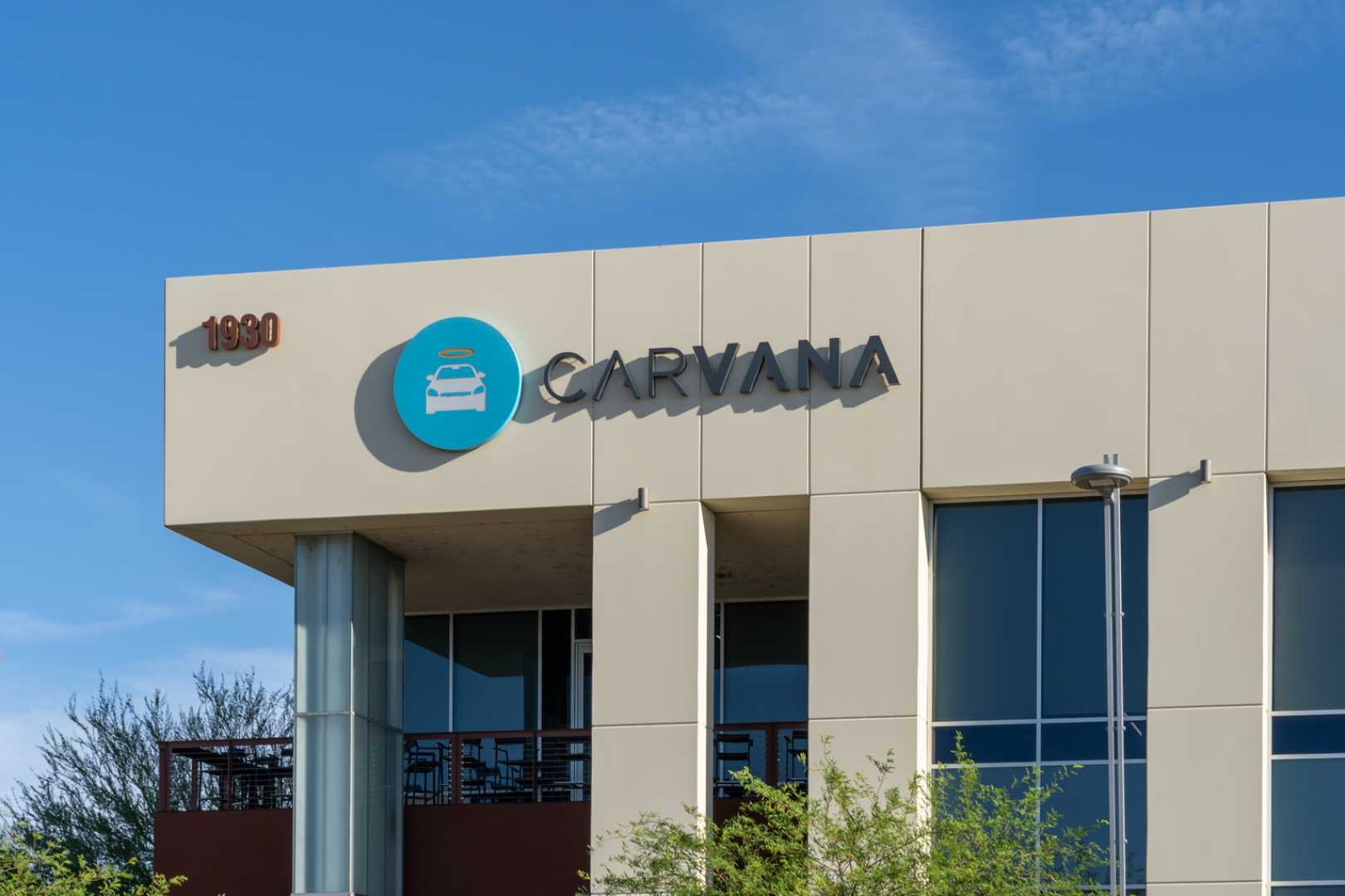 Carvana Used Car Lot With Shoppers Inspecting Vehicles