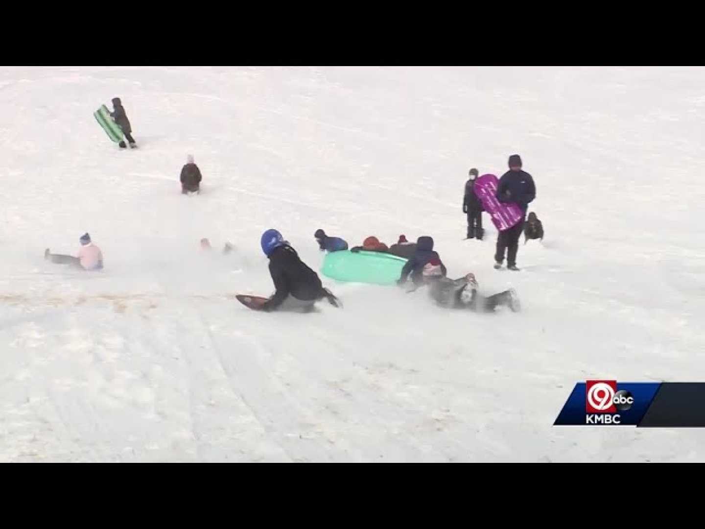 Children Sledding In Snow At Brookside Park