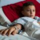 Child In Hospital Bed With Flu Symptoms