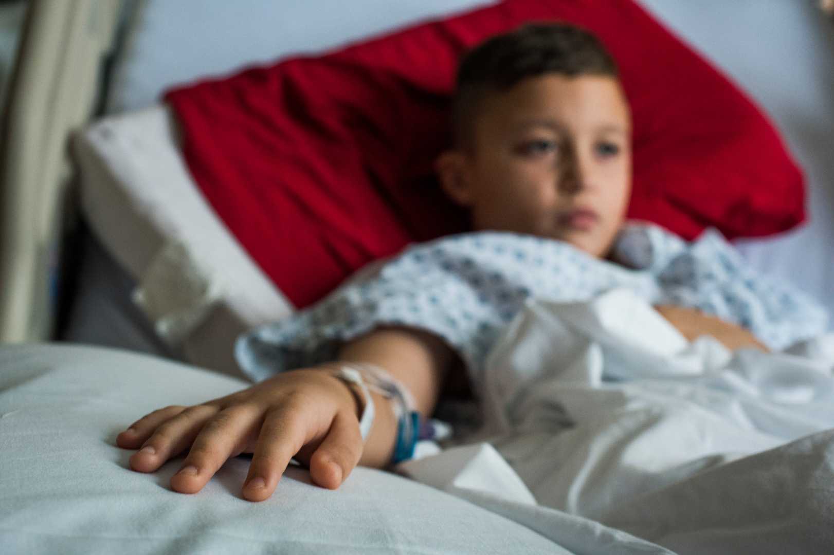 Child In Hospital Bed With Flu Symptoms