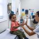 Children Receiving Vaccines In A School Clinic