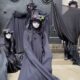 Protesters In Black Robes And Masks