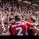 Soccer Players Celebrating Goal, Stadium Crowd