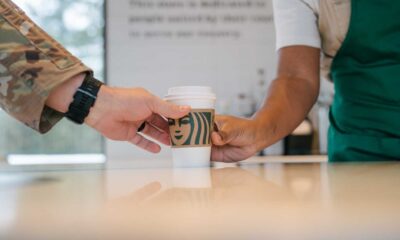 Starbucks Barista Handing Free Coffee Cup