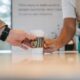 Starbucks Barista Handing Free Coffee Cup