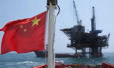 Suriname Oil Drilling Site With Chinese And U.s. Flags