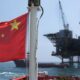 Suriname Oil Drilling Site With Chinese And U.s. Flags