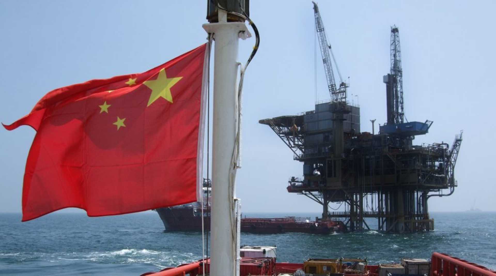 Suriname Oil Drilling Site With Chinese And U.s. Flags