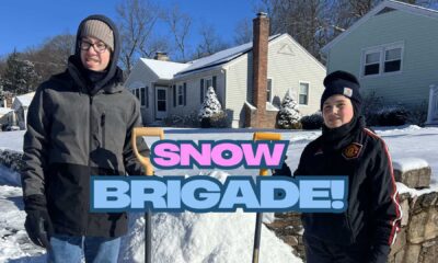 Two Teenage Volunteers Shoveling Snow In Seymour Connecticut