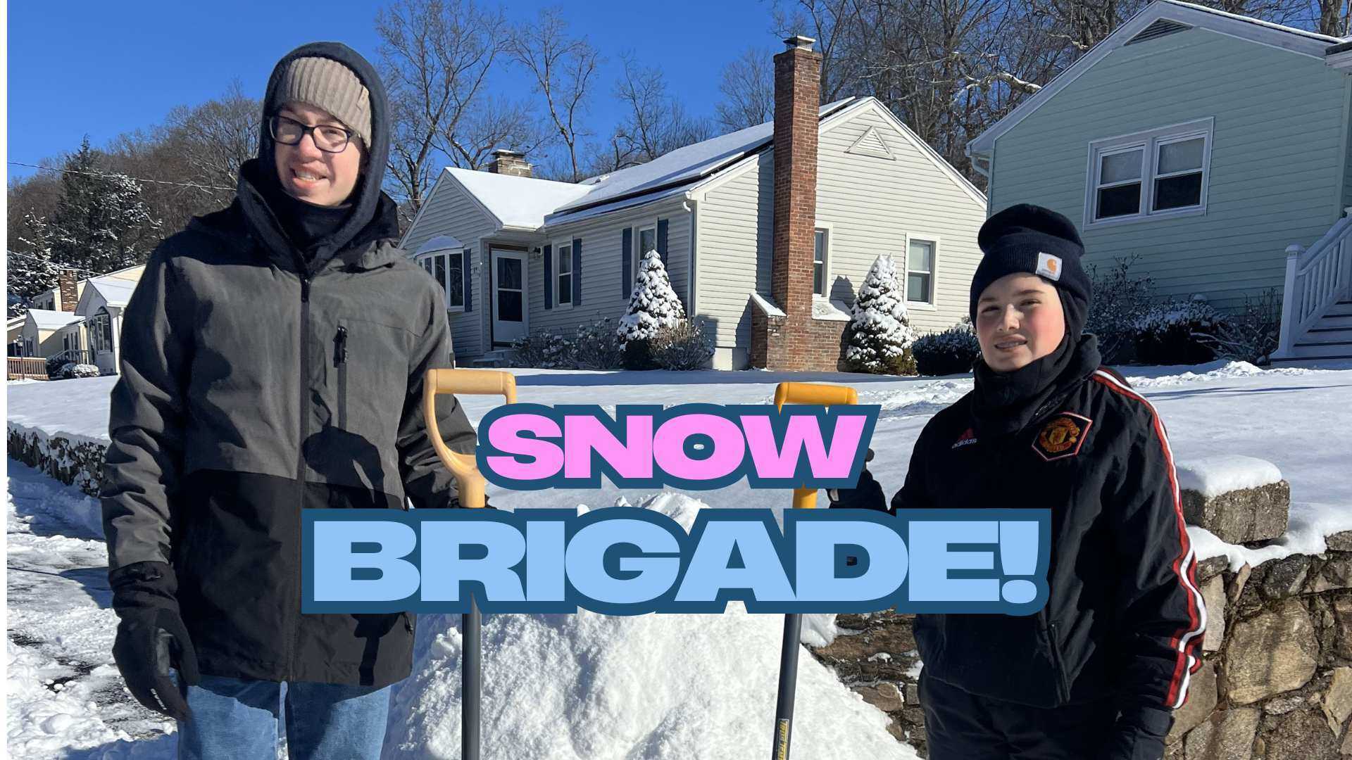 Two Teenage Volunteers Shoveling Snow In Seymour Connecticut