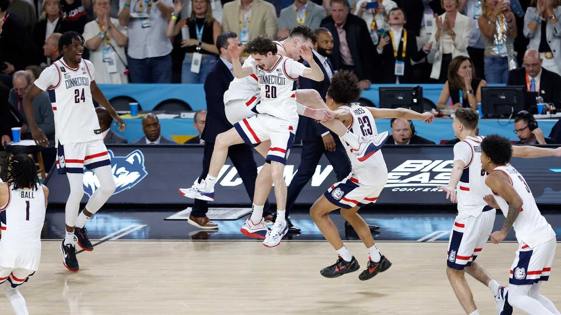 Uconn Basketball Team Celebrating On The Court