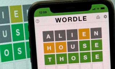 Wordle Puzzle On Digital Device With Green, Yellow, And Gray Tiles Visible