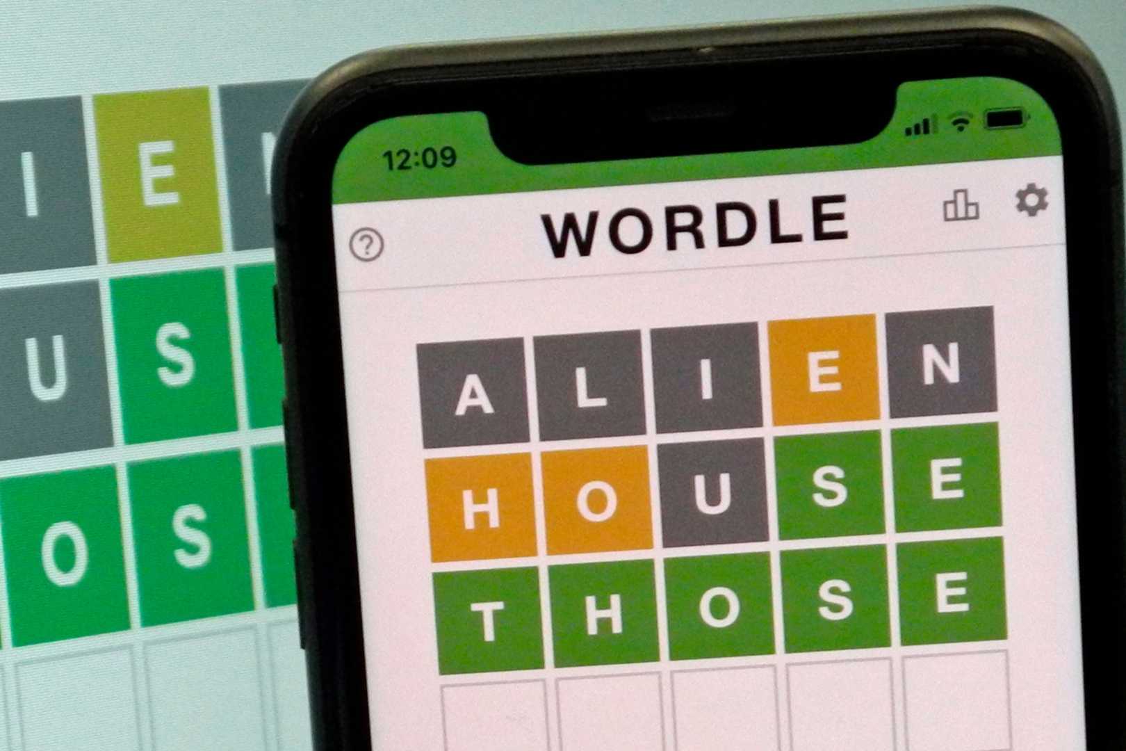 Wordle Puzzle On Digital Device With Green, Yellow, And Gray Tiles Visible