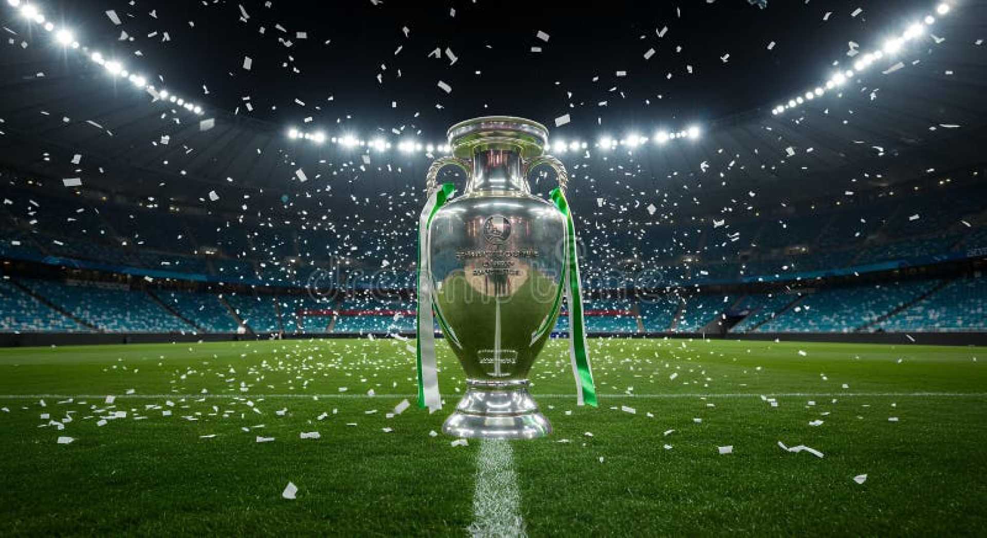 Champions League Football Trophy With Stadium In Background